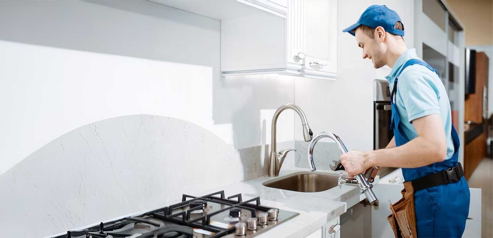 Plombier travaillant dans une cuisine